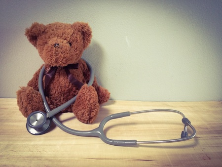 close up teddy bare and stethoscopes for doctor workingの素材
