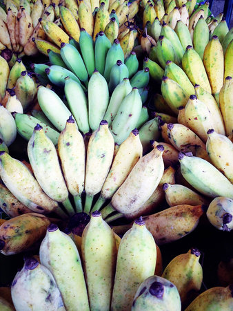 banana is not ripe sold in the fruit and vegetable marketの素材