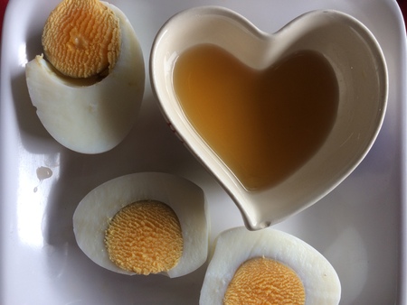 Boiled eggs on the dish with love heartの写真素材