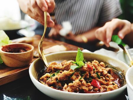 Stir fried pork with curry, spicy Thai food with herbsの写真素材