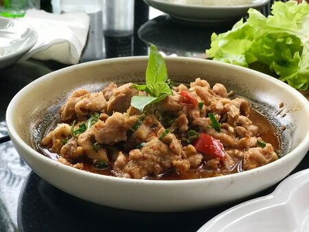 Stir fried pork with curry, spicy Thai food with herbs