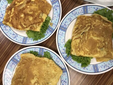 Thai style pork omelette on the decoration disc by vegetable