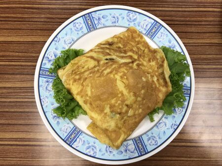 Thai style pork omelette on the decoration disc by vegetableの写真素材