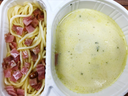 close up Spaghetti Carbonara with potato paste in paper box, food delivery conceptの写真素材