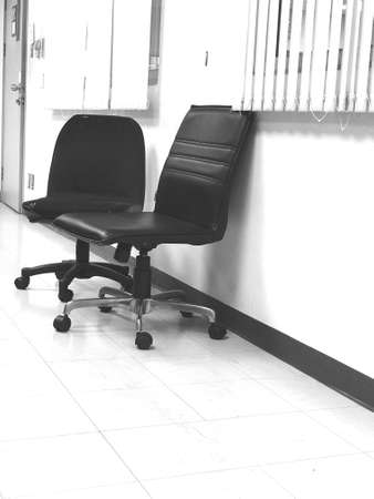 The black and white image of the chairs in the meeting room where no one is seated gives a feeling of emptyの写真素材