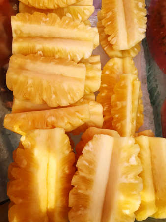 Fresh pineapple pictures, peeled and cut into pieces, frozen in a glass container for saleの写真素材