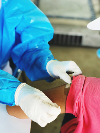 Picture of a doctor injecting covid-19 vaccination on the arm of people who come to receive service,...