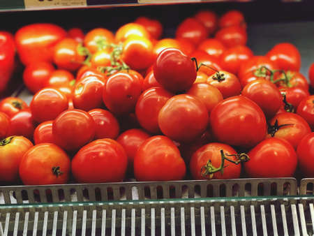 Close up raw fresh tomato put on small basket for sell in the market, fresh fruit and vegetableの写真素材