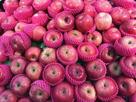 Red apples wrapped in foam, put up for sale fruit marketの写真素材