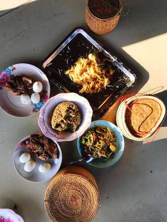 The picture above the Isan food placed on a woven mat, eating culture of Thai people in the...