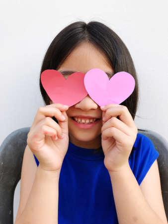 short haired girl wearing a blue dress holding a heart-shaped paper, showing each poseの写真素材