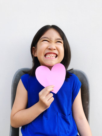 short haired girl wearing a blue dress holding a heart-shaped paper, showing each poseの写真素材