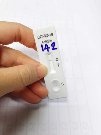 hand holding ATK or antigen test kit with negative results, meaning no coronavirus has been detected.の写真素材
