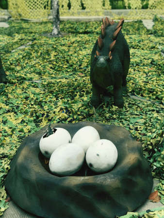 Dinosaur statues are displayed for children to see.