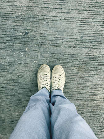 Standing on the vintage  groundfloor, walking street concept,relax your feet by take a some trip for your lifeの写真素材