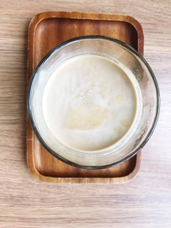 The name of the coffee menu is dirty coffee in a clear glass on a window-side table in a coffee shop.の写真素材