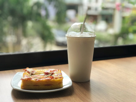 Fried eggs and toast make for an appetizing and hearty breakfast paired with a cup of white coffee in a restaurant.の写真素材