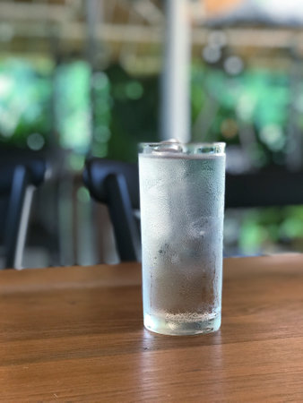 Glass of water on the table in a restaurant, shallow depth of fieldの写真素材