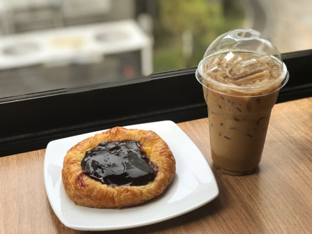 A cup of coffee and a berry pie on a wooden tableの写真素材