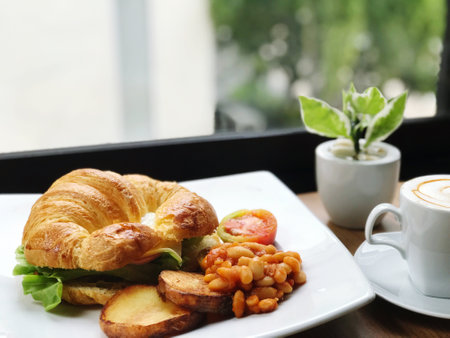 Breakfast with coffee and croissant in a cafe, selective focusの写真素材