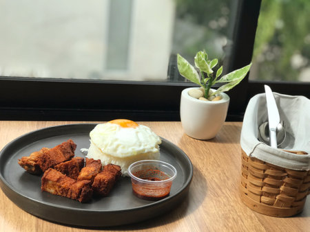 Rice with fried egg on the table in coffee shop, stock photoの写真素材