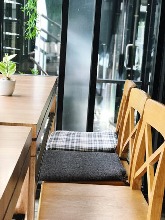 Wooden table and chair in coffee shop interior - Vintage Light Filter