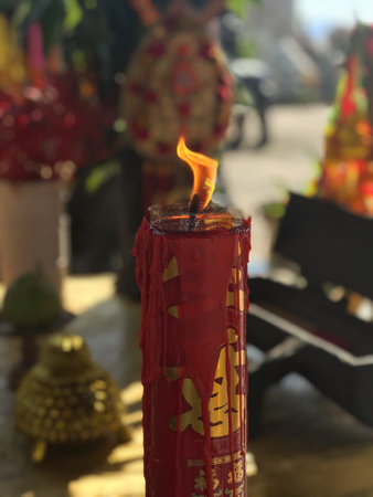 Candle in a Buddhist temple in Thailand, closeup of photo