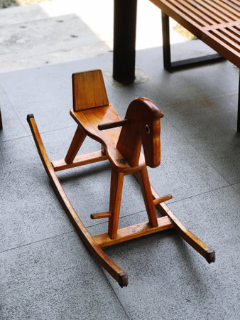 Wooden rocking chair on the floor in the park, Thailand.