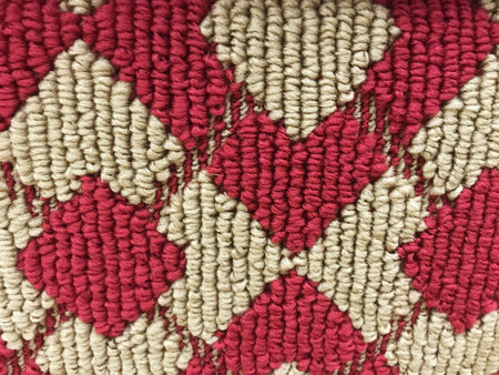 Red and white knitted carpet texture. Abstract background and texture for design.