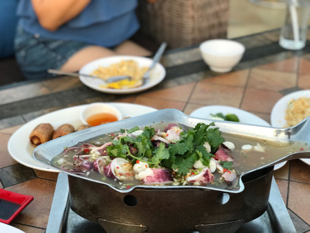 Thai spicy soup with pork and vegetables in hot pot, Thailand.