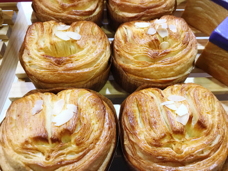 Cream puff pastry with almonds on display in the bakery shop.