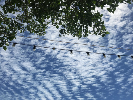 Hanging clothes line with blue sky and white clouds. Natural background.