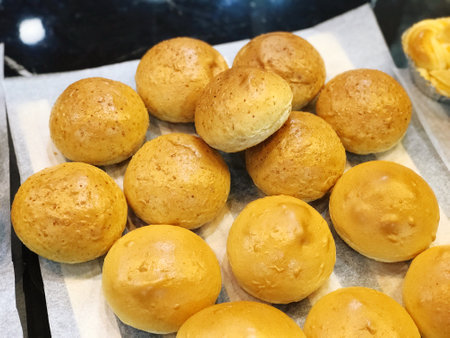Bread rolls on a baking sheet in a bakery, close-up