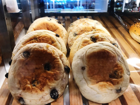 Slices of bread with raisins in bakery shop.