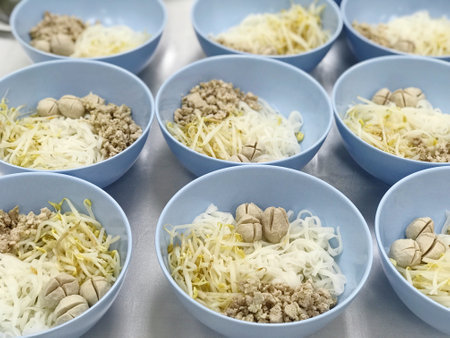 Rice vermicelli and minced pork in a blue bowlの写真素材