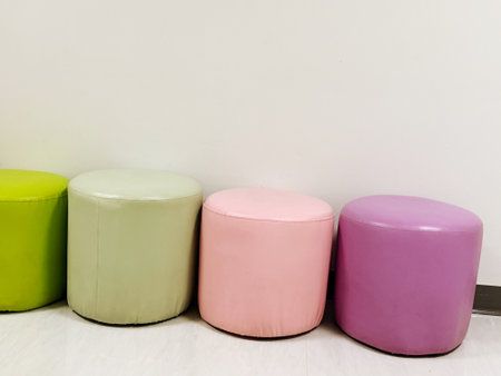 Multi-colored chairs arranged in a row with copy spaceの写真素材