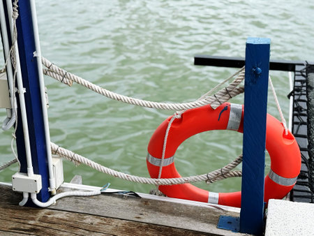 Lifebuoy on a pier in a yacht club, closeup of photo