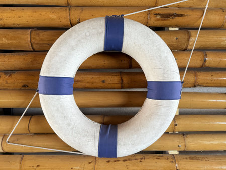 Lifebuoy hanging on a bamboo wall, closeup of photoの写真素材