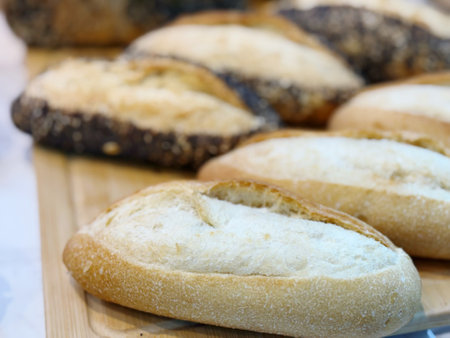 Freshly baked bread on a wooden cutting board. Selective focus.