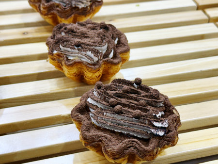 Chocolate tartlets on a wooden table. Selective focus.