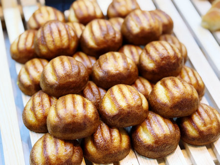 Close up of freshly baked buns on a wooden table in a bakery