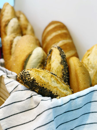 Baguettes with poppy seeds in a basket, close-up