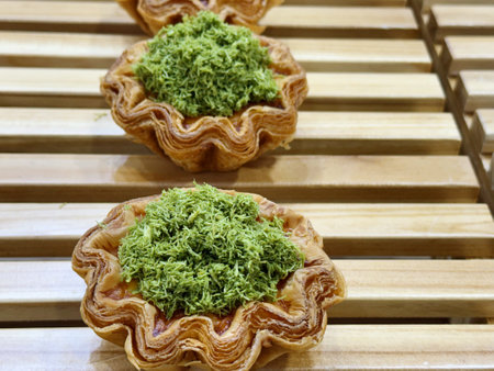 Tasty tartlets with green tea on a wooden table in a restaurant