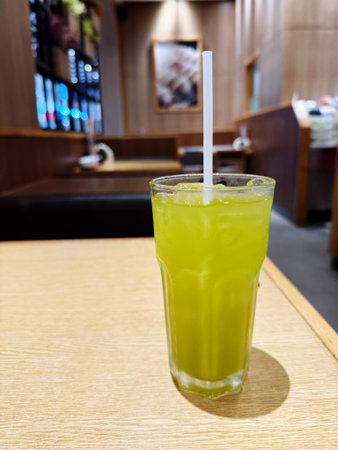 Iced green tea in a glass on a table in a cafeの写真素材