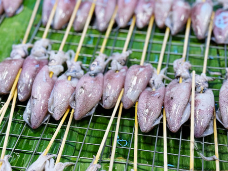 Grilled squid on the market in Thailand, closeup of photo
