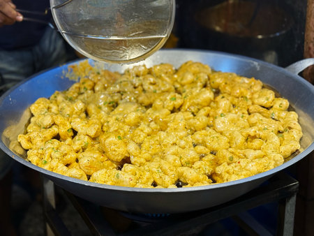 Fried cauliflower in a wok on the street food market