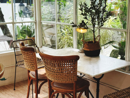 Wicker rattan chairs and table in a cozy cafe, stock photo