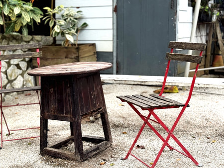 Old wooden chair and wooden table in the garden. Vintage style.