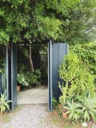 Entrance door in garden with fern and plants, nobody inside