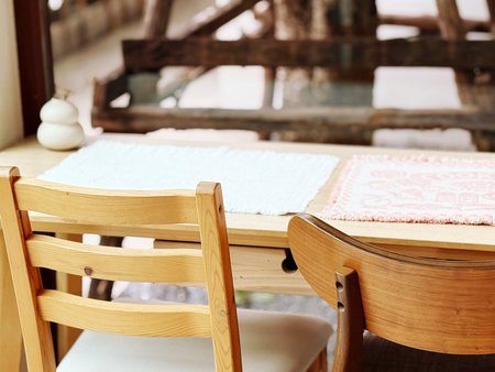 Wooden table and chairs with towels in a restaurant. Selective focus.の写真素材